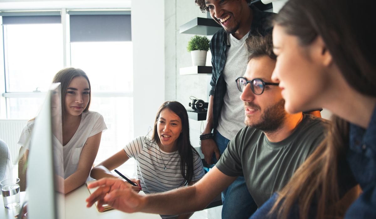 startup employees looking at a computer screen