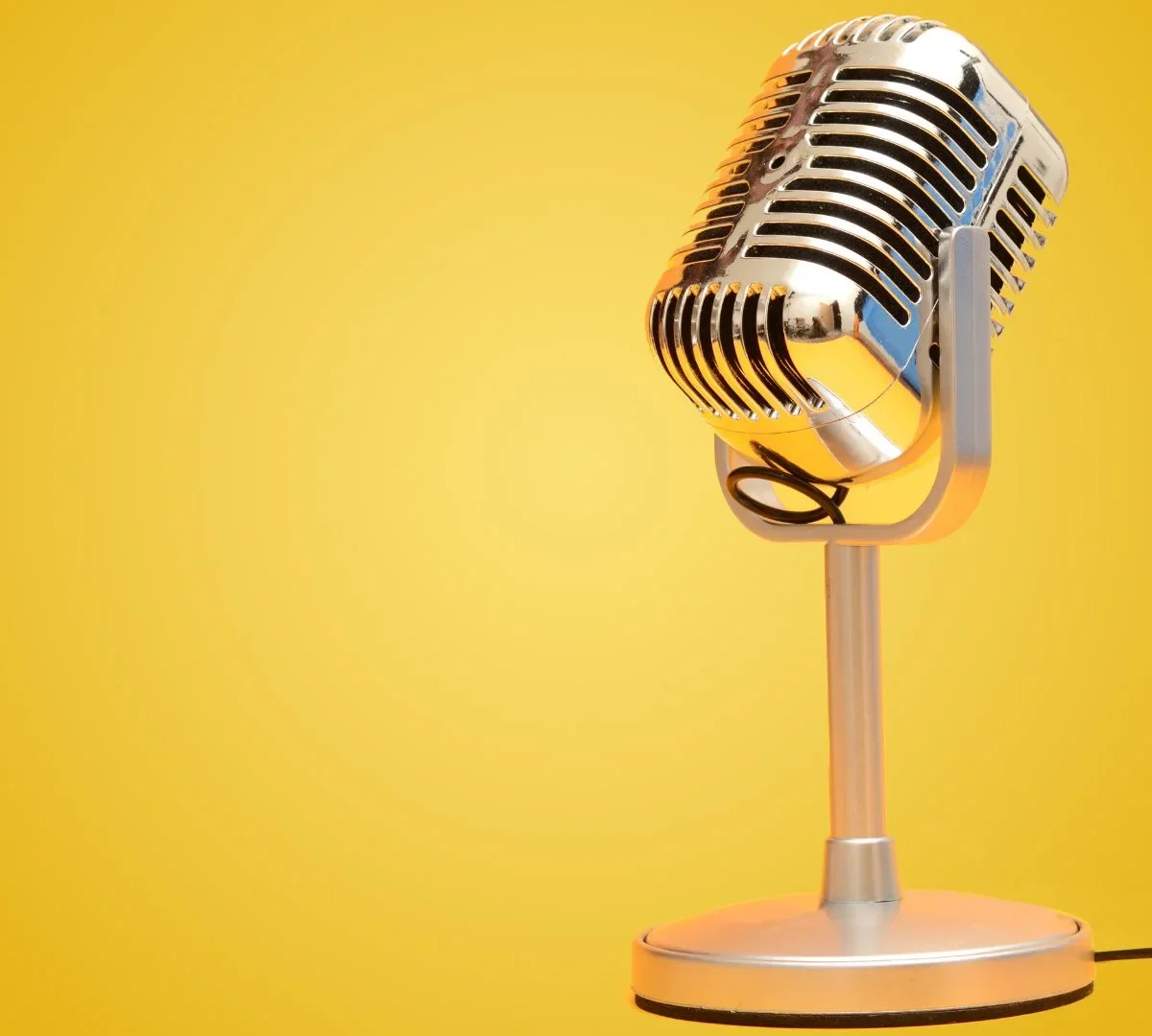 retro microphone against a yellow backdrop