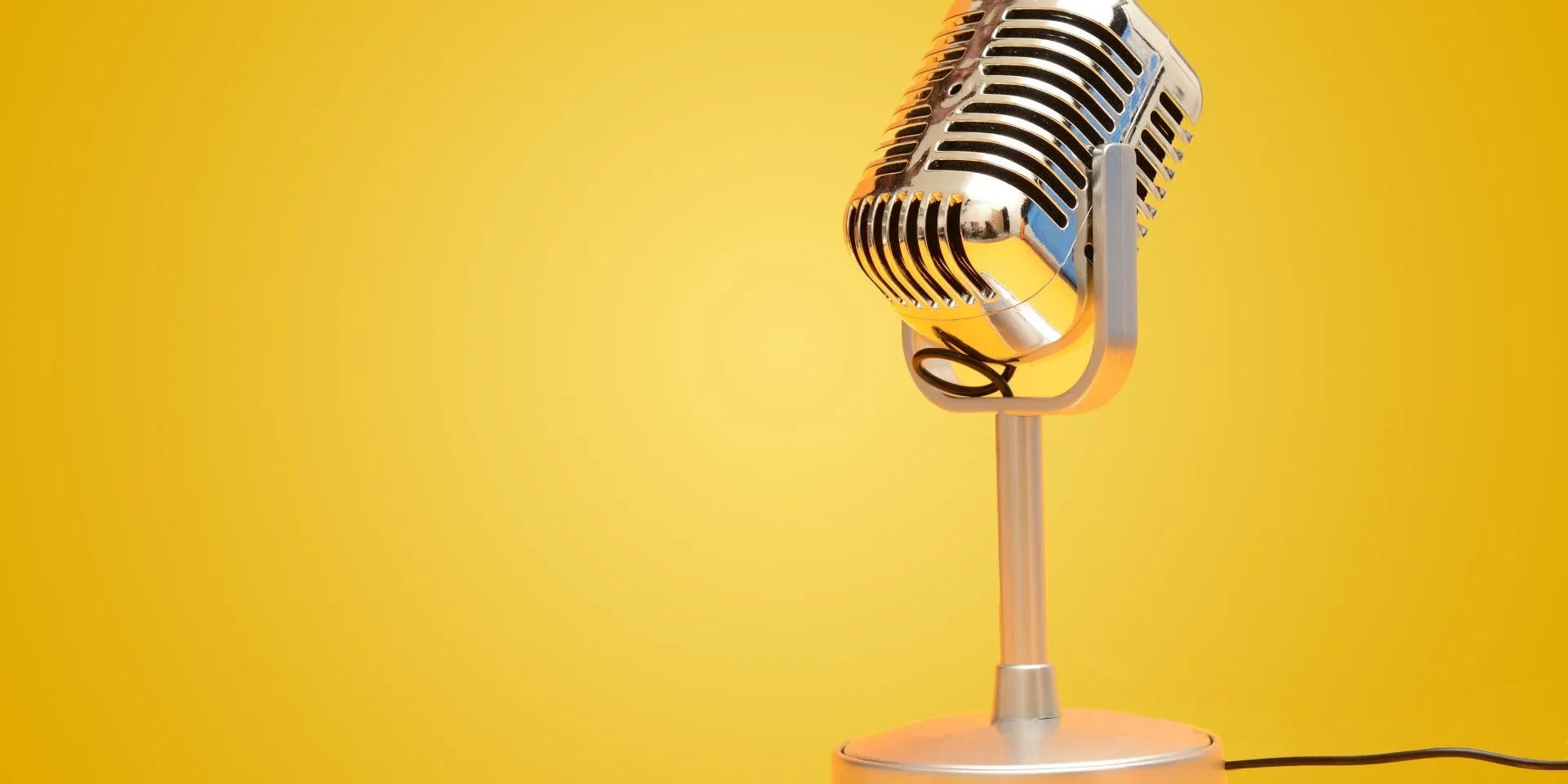 retro microphone against a yellow backdrop
