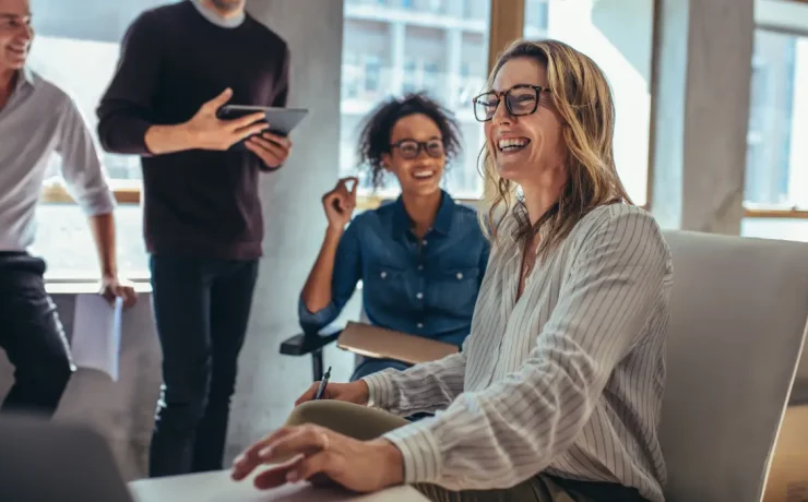 a group of people smiling and working