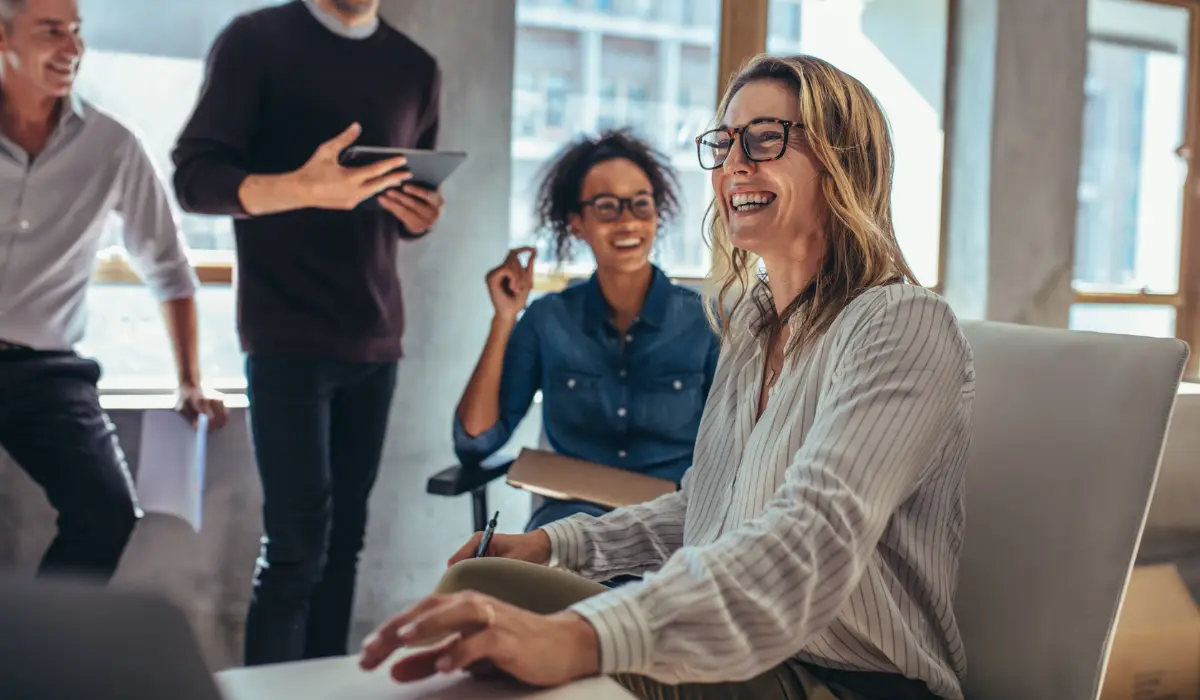a group of people smiling and working