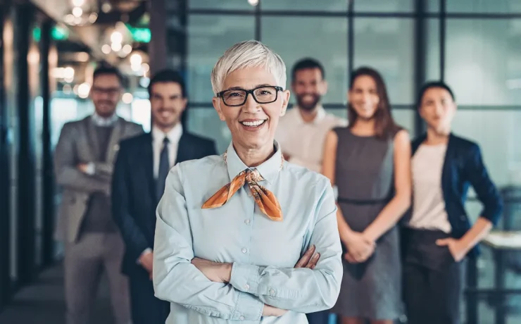 a ceo is standing in front of a team inside an office
