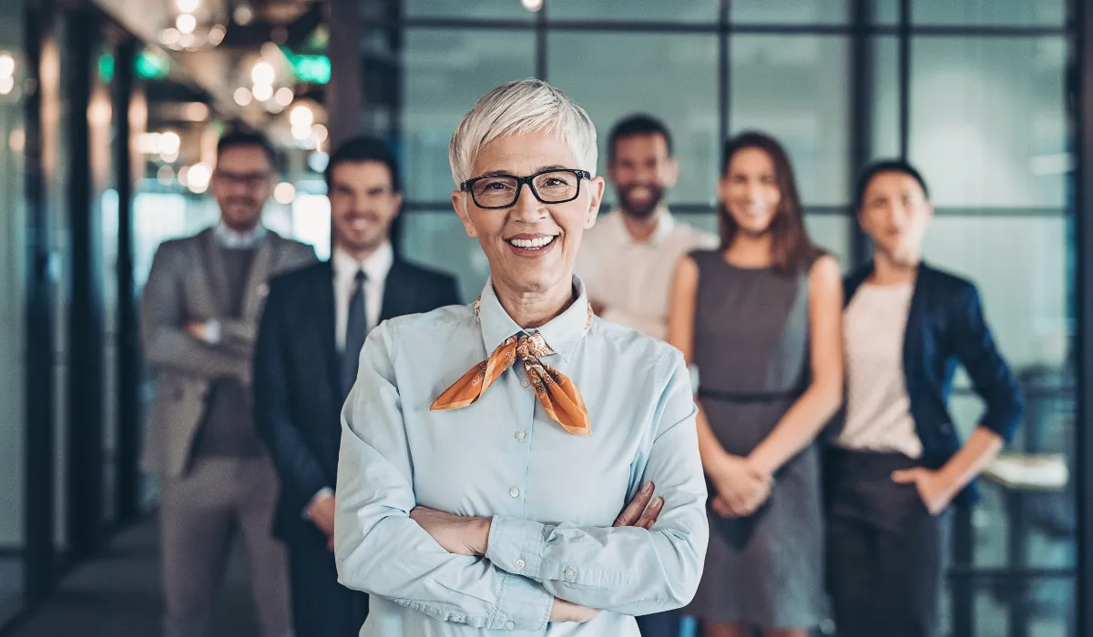 a ceo is standing in front of a team inside an office