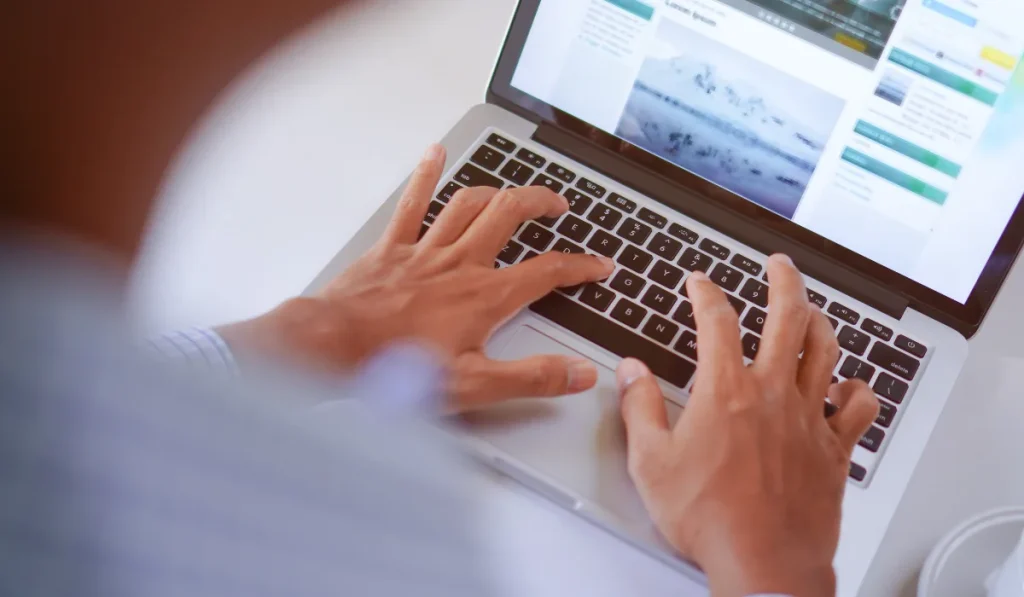 a person typing on a laptopo's keyboard