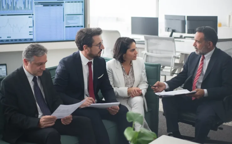 A CEO speaking to executives in an office setting.