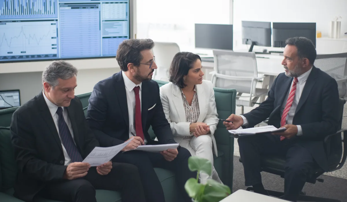 A CEO speaking to executives in an office setting.
