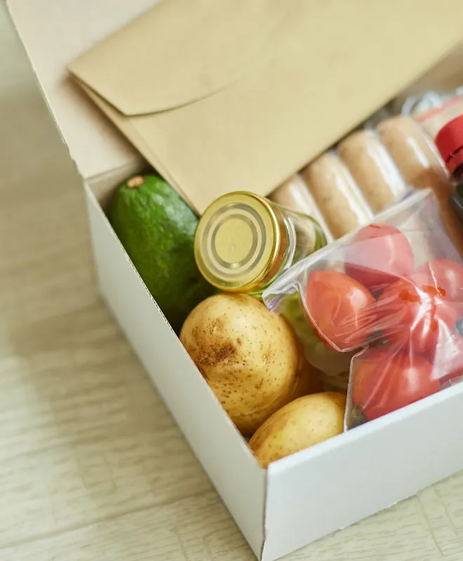 Sausages and veggies in a meal kit container