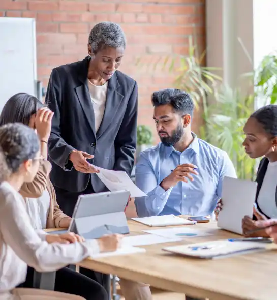 Leader showing executives a document during a crisis event.