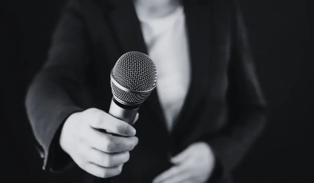 a journalist pointing a mic towards you.